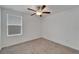 Bedroom with neutral carpet, ceiling fan, and window with horizontal blinds at 3186 Oyster Cove St, Wimauma, FL 33598