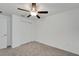 Bedroom with neutral carpet, ceiling fan, closet, and a white door at 3186 Oyster Cove St, Wimauma, FL 33598