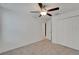Bedroom with neutral carpet, ceiling fan, closet, and a white door at 3186 Oyster Cove St, Wimauma, FL 33598