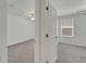 View of two bedrooms, with neutral colored walls and carpeting, through doorway at 3186 Oyster Cove St, Wimauma, FL 33598