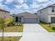 Charming single-story home with a spacious driveway and well-manicured lawn at 3186 Oyster Cove St, Wimauma, FL 33598