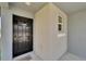 The front door is black with a welcome mat; it also has a window and gray neutral paint at 3186 Oyster Cove St, Wimauma, FL 33598