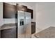 Modern kitchen featuring stainless steel appliances, granite countertops, and dark cabinetry at 3186 Oyster Cove St, Wimauma, FL 33598