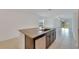 A spacious kitchen island features granite countertops, stainless steel appliances and stylish dark brown cabinets at 3186 Oyster Cove St, Wimauma, FL 33598