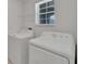 This laundry room features a window and washer and dryer at 3186 Oyster Cove St, Wimauma, FL 33598