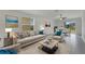 Stylishly furnished living room with ample seating, window views, and an adjacent dining area at 3186 Oyster Cove St, Wimauma, FL 33598
