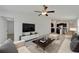 Inviting living room featuring stylish furniture, a mounted TV, and an open connection to the kitchen at 3186 Oyster Cove St, Wimauma, FL 33598