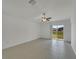 Bright, airy living room featuring neutral tile and a ceiling fan, offering a serene atmosphere at 3186 Oyster Cove St, Wimauma, FL 33598