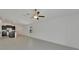 Bright living area featuring an open concept design with tile floors and access to a modern kitchen at 3186 Oyster Cove St, Wimauma, FL 33598