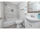 Bright bathroom with stylish marble tile in the shower/tub and a modern white vanity with a mirror at 350 Kentucky Ave, Crystal Beach, FL 34681