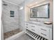 Beautiful bathroom features walk-in shower with marble tiling and mosaic accent, and white vanity at 350 Kentucky Ave, Crystal Beach, FL 34681
