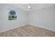 Bedroom with hardwood floors, a ceiling fan, and a window providing natural light at 350 Kentucky Ave, Crystal Beach, FL 34681