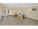 Bonus room with colorful decor, tile flooring, ceiling fan, and access to the outdoors at 350 Kentucky Ave, Crystal Beach, FL 34681