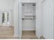 Open closet with shelving, wood floor, and multiple doors to the patio and the hallway at 350 Kentucky Ave, Crystal Beach, FL 34681
