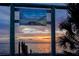 Crystal Beach Community Pier sign featuring the inscription 'Enjoy the Sunset' with vibrant sunset views at 350 Kentucky Ave, Crystal Beach, FL 34681