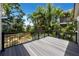 A spacious wood deck with black railings offers views of the surrounding green landscape at 350 Kentucky Ave, Crystal Beach, FL 34681