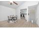 Open dining area with wood floors adjacent to modern kitchen and stairway at 350 Kentucky Ave, Crystal Beach, FL 34681