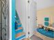 Entryway showcases staircase with bright blue accents and inviting decor at 350 Kentucky Ave, Crystal Beach, FL 34681