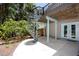 Backyard with a spiral staircase leading to the deck and a concrete patio that makes a great space for outdoor entertaining at 350 Kentucky Ave, Crystal Beach, FL 34681