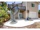 Backyard with a spiral staircase leading to the deck and a concrete patio that makes a great space for outdoor entertaining at 350 Kentucky Ave, Crystal Beach, FL 34681