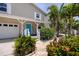 Attractive house with a delightful front porch, a well-maintained lawn, and mature palm trees, exuding curb appeal at 350 Kentucky Ave, Crystal Beach, FL 34681