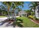 Charming home with a lush lawn, mature palm trees, and a lovely front yard, making it an inviting and tropical retreat at 350 Kentucky Ave, Crystal Beach, FL 34681