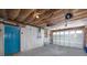 Spacious garage with blue door and visible ceiling insulation at 350 Kentucky Ave, Crystal Beach, FL 34681