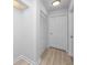 Hallway featuring hardwood floors, white trim, closet with louvered doors, and neutral walls at 350 Kentucky Ave, Crystal Beach, FL 34681