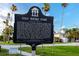 Gulf Shore Park historical marker surrounded by lush greenery and tall palm trees in Crystal Beach, Florida at 350 Kentucky Ave, Crystal Beach, FL 34681