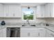 Kitchen featuring stainless steel appliances, stone countertops, and a window with a garden view at 350 Kentucky Ave, Crystal Beach, FL 34681