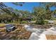 Beautiful park landscape with walking paths, benches, and a gazebo nestled among mature trees and plants at 350 Kentucky Ave, Crystal Beach, FL 34681