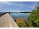 Water view from pier with boat in the distance surrounded by mangroves & clear water at 350 Kentucky Ave, Crystal Beach, FL 34681