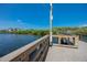 Pier view overlooking the calm water and lush greenery; residential area in distance at 350 Kentucky Ave, Crystal Beach, FL 34681