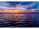 Beautiful sunset on the water, featuring light cloud coverage and rippling waves at 350 Kentucky Ave, Crystal Beach, FL 34681