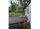 Outdoor space with a metal table and chairs, surrounded by green trees at 3614 E Grove St, Tampa, FL 33610