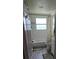 A bathroom with white tile and a shower/bath combination with curtain at 3614 E Grove St, Tampa, FL 33610
