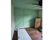 View of a bedroom featuring wood paneling and hardwood floors at 3614 E Grove St, Tampa, FL 33610