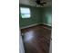 A bedroom featuring wood-look flooring, a window, and plenty of natural light at 3614 E Grove St, Tampa, FL 33610