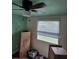 View of a bedroom featuring a ceiling fan and a window with blinds at 3614 E Grove St, Tampa, FL 33610