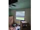 View of a bedroom featuring a ceiling fan and a window with blinds at 3614 E Grove St, Tampa, FL 33610