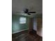 View of a bedroom featuring a ceiling fan, a closet, and a window with blinds at 3614 E Grove St, Tampa, FL 33610