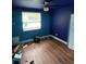 This bedroom features sleek wood-look flooring, a window, ceiling fan and plenty of natural light at 3614 E Grove St, Tampa, FL 33610