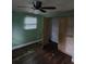 View of a bedroom featuring a ceiling fan, a closet, and a window with blinds at 3614 E Grove St, Tampa, FL 33610