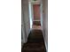 A pink hallway with wood laminate flooring, a closet, and white doors at 3614 E Grove St, Tampa, FL 33610