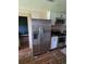 Kitchen with stainless steel fridge and appliances, granite countertops, and white cabinetry at 3614 E Grove St, Tampa, FL 33610