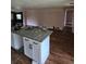Open-concept kitchen featuring an island and hardwood floors at 3614 E Grove St, Tampa, FL 33610