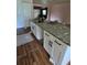 Kitchen with granite countertops, stainless steel sink, and white cabinetry at 3614 E Grove St, Tampa, FL 33610