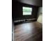 A room with damaged walls and wood laminate flooring, in need of repair at 3614 E Grove St, Tampa, FL 33610