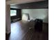 Room with unfinished walls, new hardwood floors, and a window at 3614 E Grove St, Tampa, FL 33610