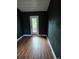 Room featuring dark walls and wood-look floors with a glass paneled door at 3614 E Grove St, Tampa, FL 33610